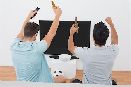 simsearch:628-05817772,k - Rear view of two excited soccer fans watching tv Stock Photo - Budget Royalty-Free & Subscription, Code: 400-07750635