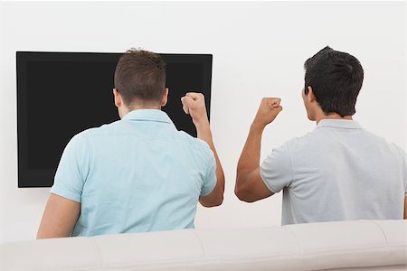 simsearch:628-05817772,k - Rear view of two excited soccer fans watching tv Stock Photo - Budget Royalty-Free & Subscription, Code: 400-07750790