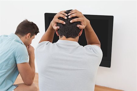 simsearch:628-05817772,k - Rear view of two tensed soccer fans watching tv Stock Photo - Budget Royalty-Free & Subscription, Code: 400-07750791