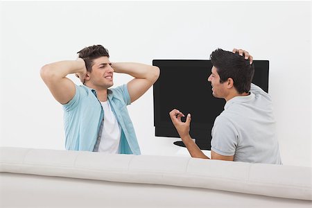 simsearch:628-05817772,k - Side view of two tensed soccer fans watching tv Stock Photo - Budget Royalty-Free & Subscription, Code: 400-07750793