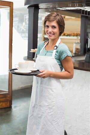 simsearch:400-07750853,k - Pretty barista smiling at camera holding tray at the coffee shop Stock Photo - Budget Royalty-Free & Subscription, Code: 400-07750848