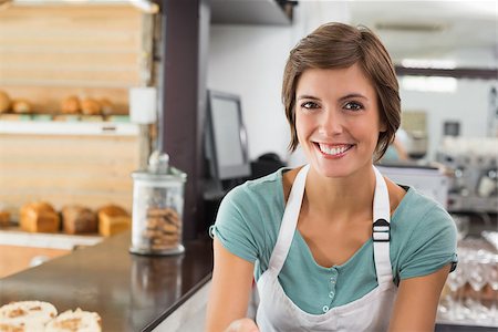 simsearch:400-07750853,k - Pretty barista smiling at camera at the coffee shop Stock Photo - Budget Royalty-Free & Subscription, Code: 400-07750856