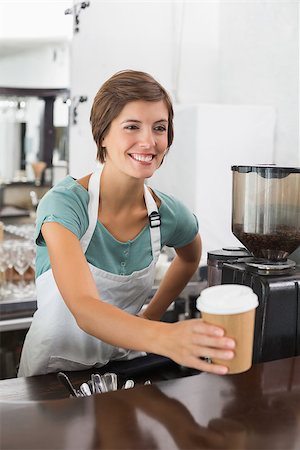 simsearch:400-07750853,k - Pretty barista holding disposable cup at the coffee shop Stock Photo - Budget Royalty-Free & Subscription, Code: 400-07750858