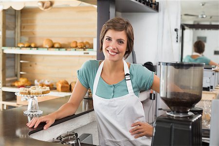 simsearch:400-07750853,k - Pretty barista smiling at camera at the coffee shop Stock Photo - Budget Royalty-Free & Subscription, Code: 400-07750859