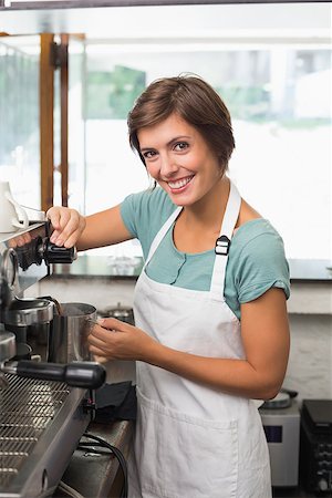 simsearch:400-07750853,k - Pretty barista steaming jug of milk at coffee machine at the coffee shop Stock Photo - Budget Royalty-Free & Subscription, Code: 400-07750866