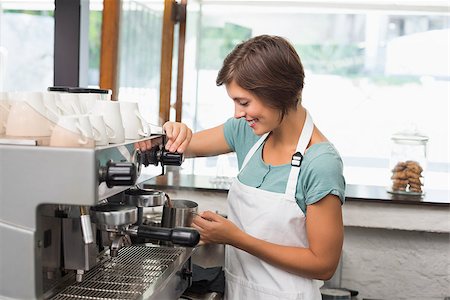 simsearch:400-07750853,k - Pretty barista steaming jug of milk at coffee machine at the coffee shop Stock Photo - Budget Royalty-Free & Subscription, Code: 400-07750867