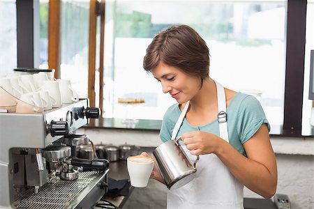 simsearch:400-07750853,k - Pretty barista pouring milk into cup of coffee at the coffee shop Stock Photo - Budget Royalty-Free & Subscription, Code: 400-07750861