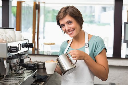 simsearch:400-07750853,k - Pretty barista pouring milk into cup of coffee at the coffee shop Stock Photo - Budget Royalty-Free & Subscription, Code: 400-07750862
