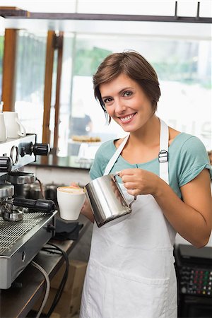 simsearch:400-07750853,k - Pretty barista pouring milk into cup of coffee at the coffee shop Stock Photo - Budget Royalty-Free & Subscription, Code: 400-07750863