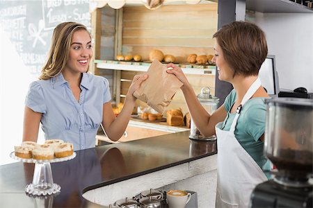 simsearch:400-07750853,k - Barista serving a happy customer at the coffee shop Stock Photo - Budget Royalty-Free & Subscription, Code: 400-07750878