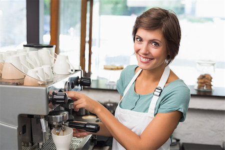 simsearch:400-07750853,k - Pretty barista making coffee smiling at camera at the coffee shop Stock Photo - Budget Royalty-Free & Subscription, Code: 400-07750870