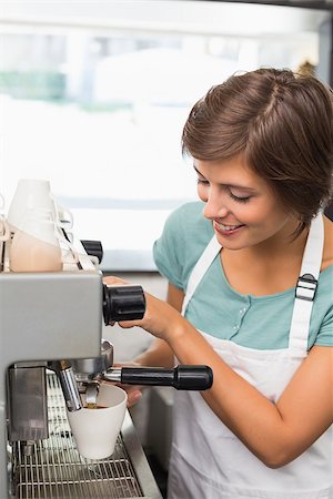 simsearch:400-07750853,k - Pretty barista making coffee smiling at camera at the coffee shop Stock Photo - Budget Royalty-Free & Subscription, Code: 400-07750871