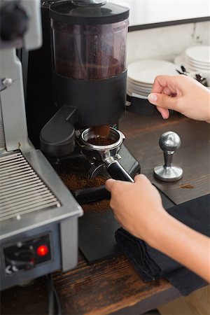 simsearch:400-07750853,k - Barista grinding fresh coffee beans at the coffee shop Stock Photo - Budget Royalty-Free & Subscription, Code: 400-07750872