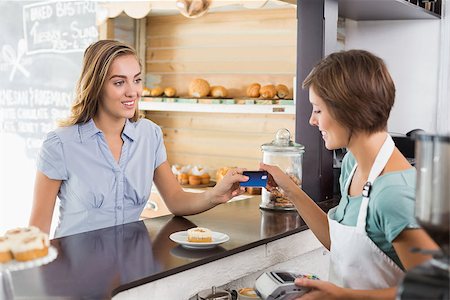 simsearch:400-07750853,k - Barista serving a happy customer at the coffee shop Stock Photo - Budget Royalty-Free & Subscription, Code: 400-07750880