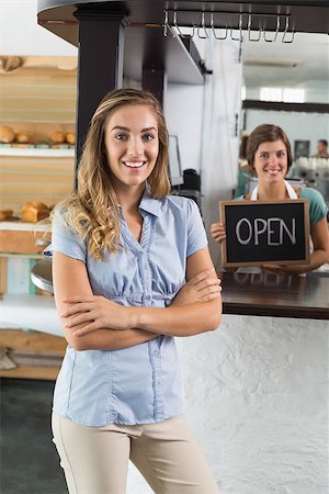 simsearch:400-07750853,k - Pretty waitress and customer smiling at camera at the coffee shop Stock Photo - Budget Royalty-Free & Subscription, Code: 400-07750894
