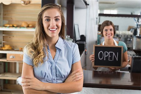 simsearch:400-07750853,k - Pretty waitress and customer smiling at camera at the coffee shop Stock Photo - Budget Royalty-Free & Subscription, Code: 400-07750895