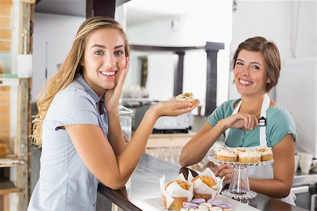 simsearch:400-07750853,k - Pretty waitress serving cupcake to customer at the coffee shop Stock Photo - Budget Royalty-Free & Subscription, Code: 400-07750890