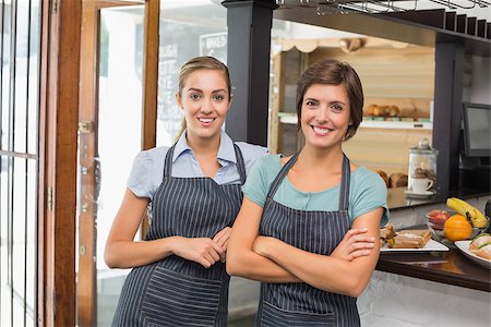 simsearch:400-07750853,k - Pretty waitresses smiling at camera at the coffee shop Stock Photo - Budget Royalty-Free & Subscription, Code: 400-07750905