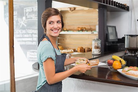 simsearch:400-07750853,k - Pretty waitress holding plate of food at the coffee shop Stock Photo - Budget Royalty-Free & Subscription, Code: 400-07750901
