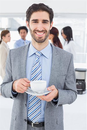Smiling businessman with a drink at work Stock Photo - Budget Royalty-Free & Subscription, Code: 400-07751854