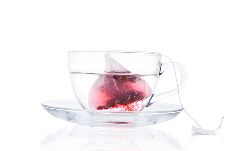 simsearch:400-04273561,k - Tea Bag In Transparent Cup With Water Isolated On White Background. Red fruit tea slowly dissolving in hot water. Healthy drinking. Stock Photo - Budget Royalty-Free & Subscription, Code: 400-07771420
