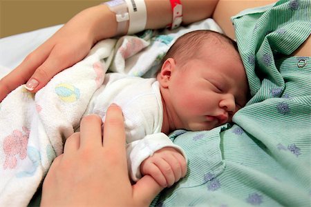 Sleeping newborn baby in the arms of my mother in hospital Stock Photo - Budget Royalty-Free & Subscription, Code: 400-07772597