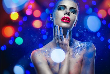 Beautiful woman with creative bright make-up over glowing lights background Stock Photo - Budget Royalty-Free & Subscription, Code: 400-07793894