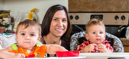A mother in the kitchen poses with babies Stock Photo - Budget Royalty-Free & Subscription, Code: 400-07816964
