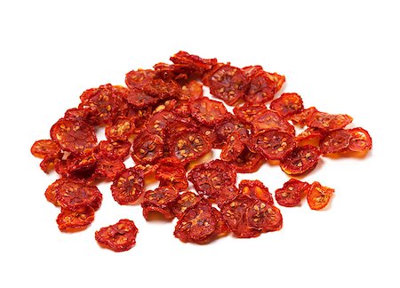 dehydrated - Dried slices of tomato. Isolated on white background. Foto de stock - Super Valor sin royalties y Suscripción, Código: 400-07817359