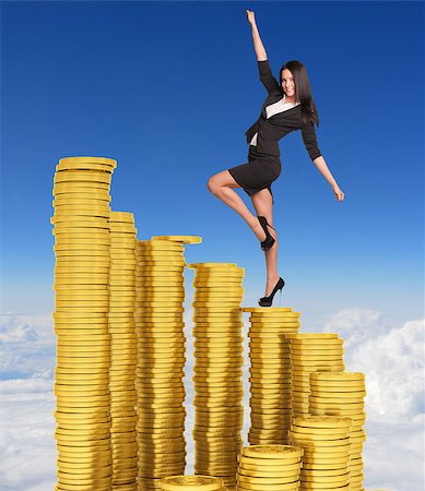 Businesswoman climbing stairs of gold coins. Sky and clouds in background Stock Photo - Budget Royalty-Free & Subscription, Code: 400-07826037