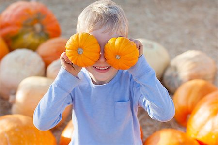 active little boy having fun at pumpkin patch Stock Photo - Budget Royalty-Free & Subscription, Code: 400-07828233