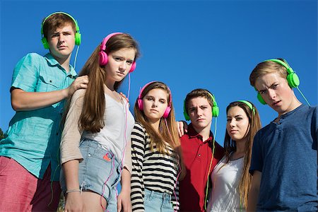 Group of offended teens in pink and green headphones Stock Photo - Budget Royalty-Free & Subscription, Code: 400-07828616