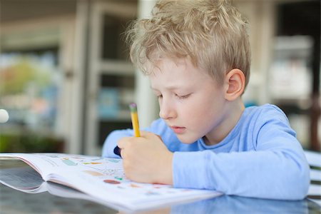 simsearch:695-03381153,k - concentrated little boy doing homework Stock Photo - Budget Royalty-Free & Subscription, Code: 400-07822521