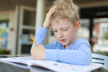 simsearch:695-03381153,k - concentrated little boy doing homework Stock Photo - Budget Royalty-Free & Subscription, Code: 400-07822523