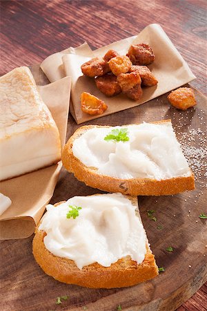 simsearch:400-04885499,k - Bread slice with lard, cracklings and bacon on wooden background. Traditional culinary eating. Stock Photo - Budget Royalty-Free & Subscription, Code: 400-07822702