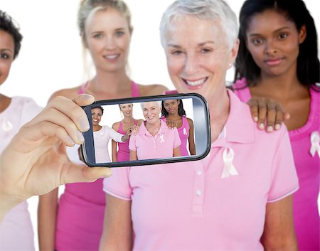 simsearch:400-07835111,k - Composite image of hand holding smartphone showing photograph of breast cancer activists Stock Photo - Budget Royalty-Free & Subscription, Code: 400-07834634