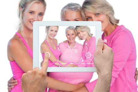 Composite image of hand holding device showing photograph of breast cancer activists Stock Photo - Budget Royalty-Free & Subscription, Code: 400-07834697