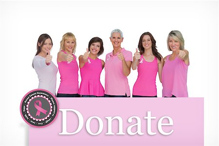simsearch:400-07835111,k - Positive women posing with pink top for breast cancer against pink card Stock Photo - Budget Royalty-Free & Subscription, Code: 400-07834870