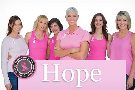 simsearch:400-07835111,k - Enthusiastic women posing with pink tops for breast cancer against pink card Stock Photo - Budget Royalty-Free & Subscription, Code: 400-07834871
