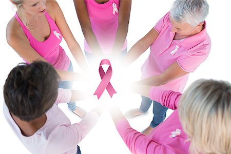 simsearch:400-07835111,k - Group wearing pink and ribbons for breast cancer with hands together against breast cancer awareness ribbon Stock Photo - Budget Royalty-Free & Subscription, Code: 400-07835033