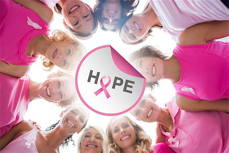 simsearch:400-07835111,k - Cheerful women in circle wearing pink for breast cancer against breast cancer awareness message Stock Photo - Budget Royalty-Free & Subscription, Code: 400-07835052