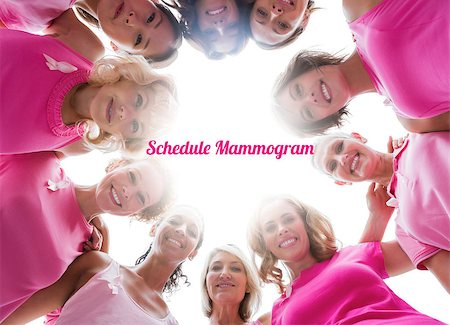 simsearch:400-07834847,k - Cheerful women smiling in circle wearing pink for breast cancer on white background Stock Photo - Budget Royalty-Free & Subscription, Code: 400-07835093