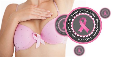 simsearch:400-07835111,k - Woman in bra with breast cancer awareness ribbon against pink breast cancer awareness badges Stock Photo - Budget Royalty-Free & Subscription, Code: 400-07835109
