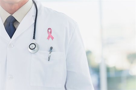 Doctor wearing lab coat wearing breast cancer awareness ribbon Stock Photo - Budget Royalty-Free & Subscription, Code: 400-07835169