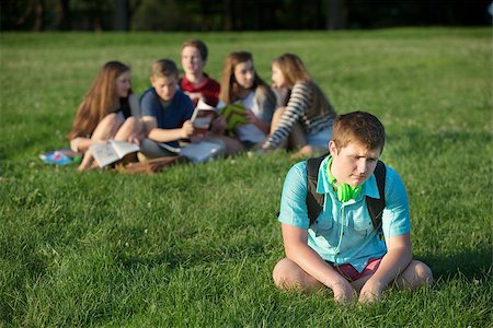 Lonely teen male sitting away from group Stock Photo - Budget Royalty-Free & Subscription, Code: 400-07831420