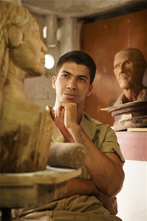 simsearch:400-07899762,k - Portrait of happy young student in art class, learning crafts profession, looking at wooden statue and smiling. Success, career and confidence Stock Photo - Budget Royalty-Free & Subscription, Code: 400-07894261