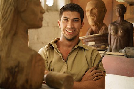 simsearch:400-07899762,k - Portrait of man working, young student in art class, learning crafts profession, working with wooden statue and looking at camera Stock Photo - Budget Royalty-Free & Subscription, Code: 400-07894263