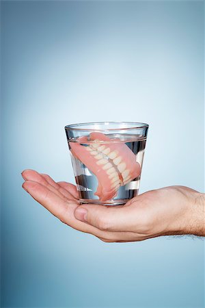 dentures - Man holding a glass containing old dentures. Stock Photo - Budget Royalty-Free & Subscription, Code: 400-07894453