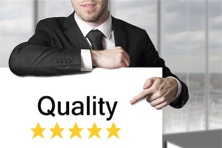 ranked - businessman in black suit pointing on sign quality golden rating stars Stock Photo - Budget Royalty-Free & Subscription, Code: 400-07897129