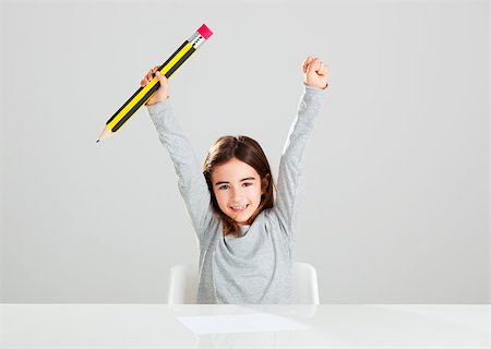pencil painting pictures images kids - Beautiful little girl in a desk playing with a big pencil, against a gray background Stock Photo - Budget Royalty-Free & Subscription, Code: 400-07897682